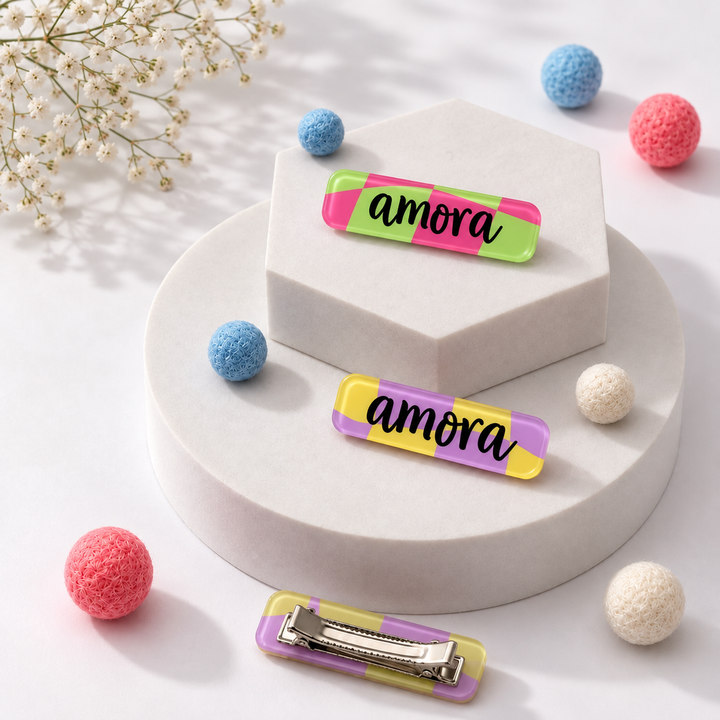 Pink checkers name hair clips close-up